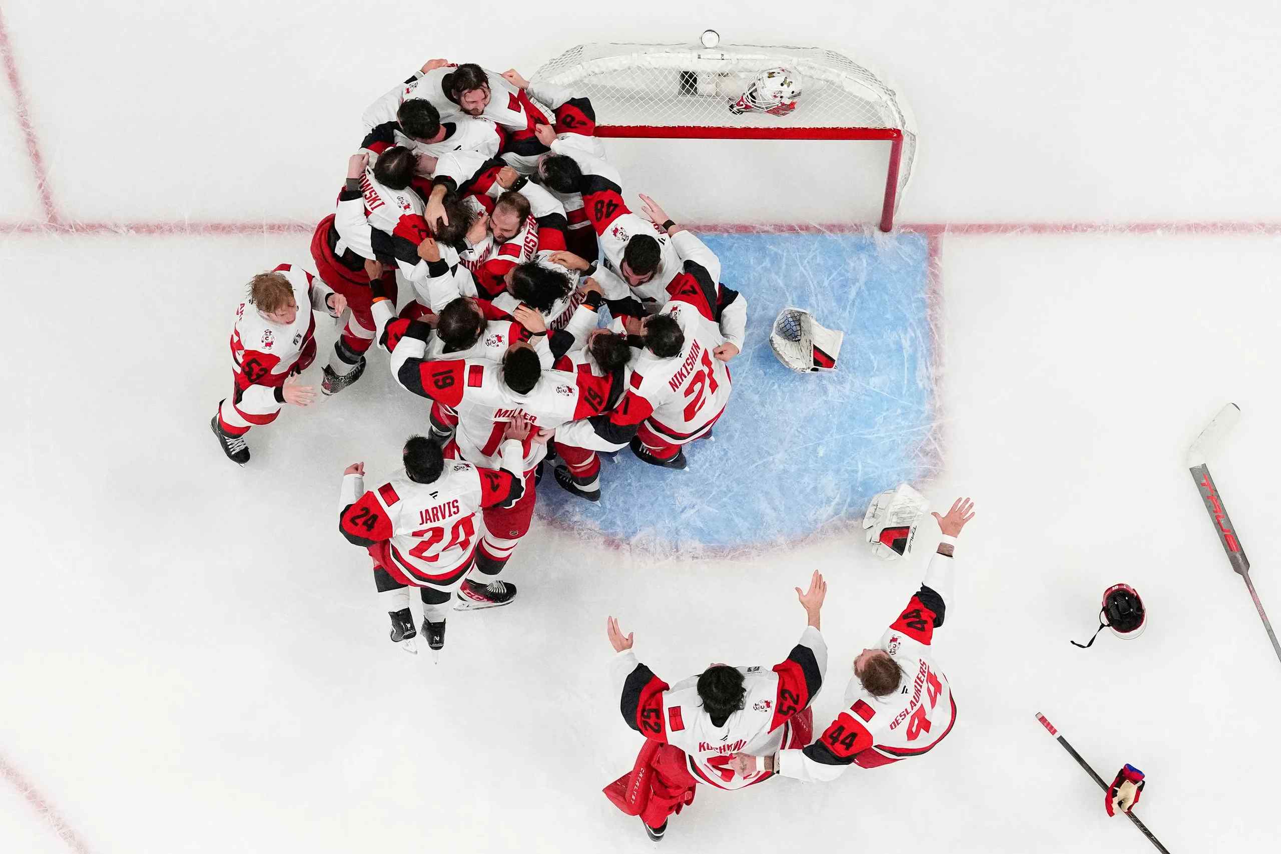 Carolina Hurricanes mobbing their goalkeeper after winning the Stanley Cup.